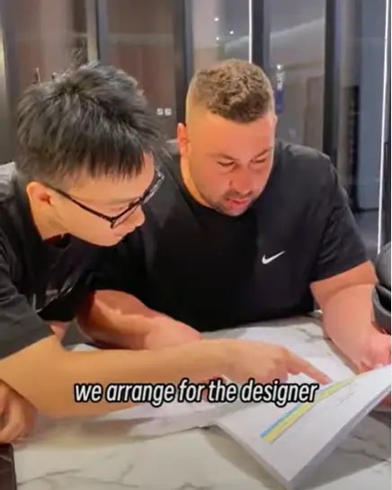 Villa client reviewing plans with a George Group designer